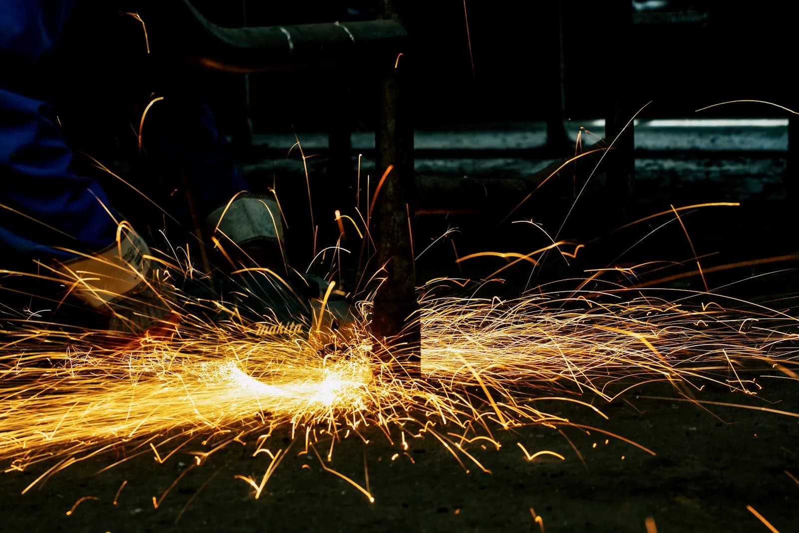 A fabricator welding a steel section in the workshop.